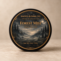 Forest Mist premium shave soap by Salve & Oak Co. in a black tub with a misty pine forest label