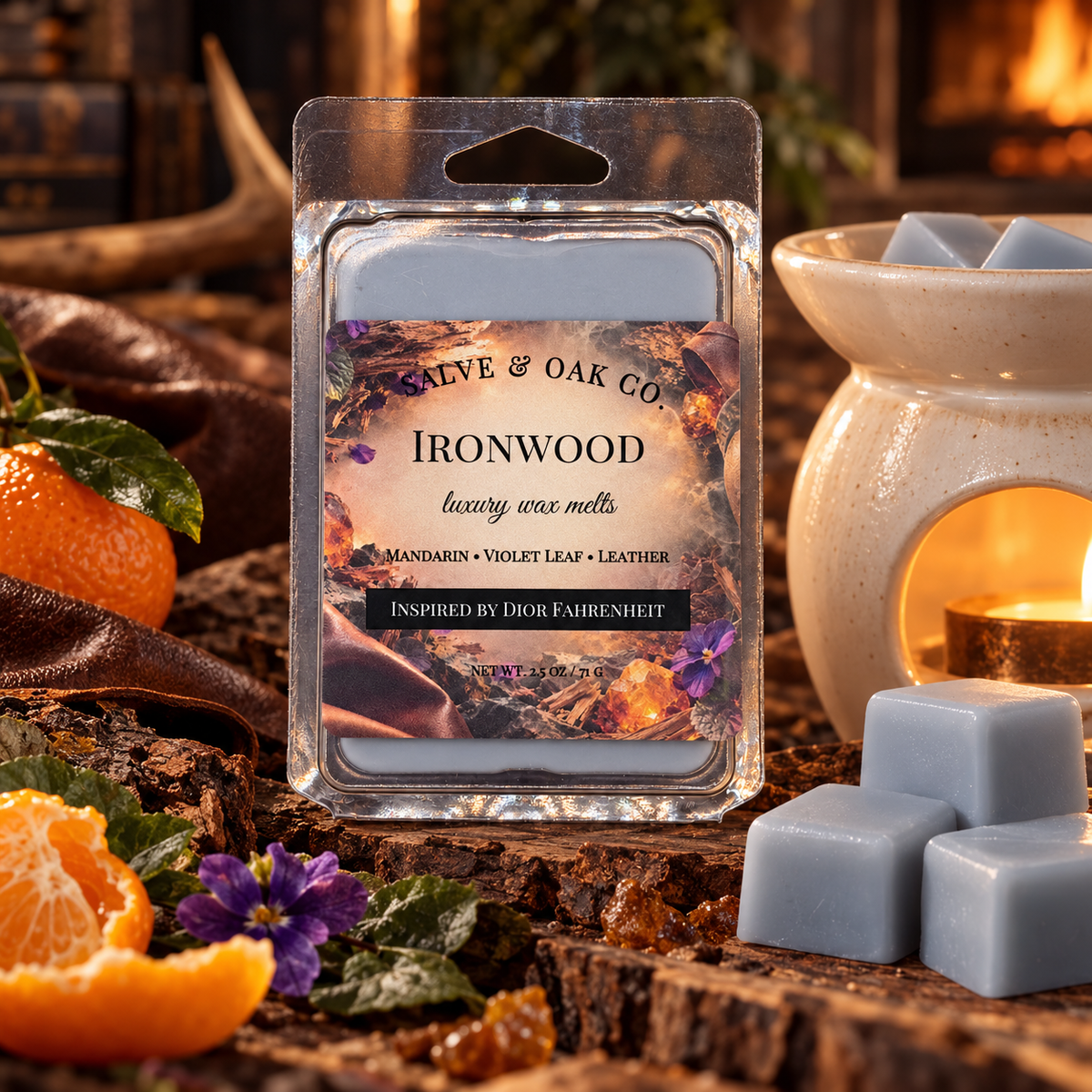 Ironwood wax melts surrounded by mandarin, violet foliage, leather, and textured wood beside a glowing warmer.