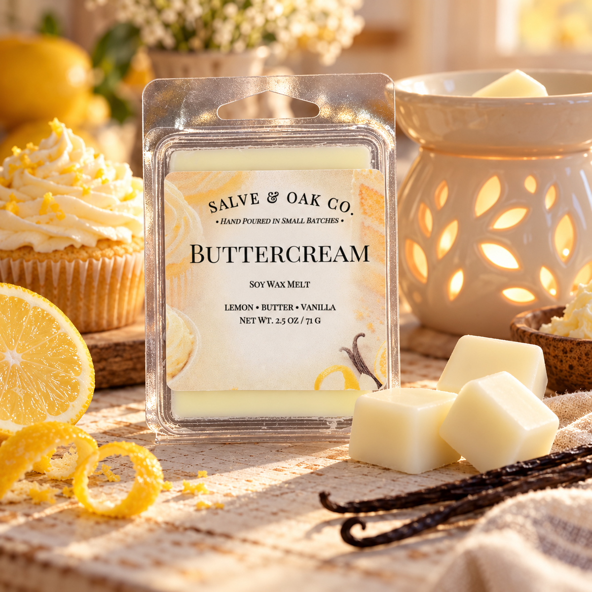Buttercream wax melts with frosted cupcakes, lemon slices, vanilla pods, and a glowing ceramic warmer in warm morning light.