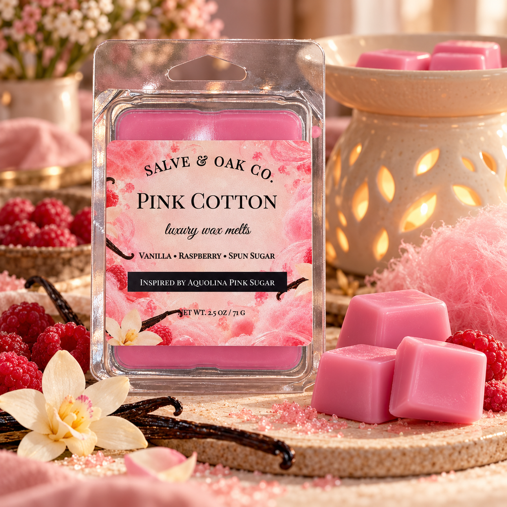 Pink Cotton wax melts surrounded by raspberries, pink spun sugar, vanilla pods, and a glowing ceramic warmer.