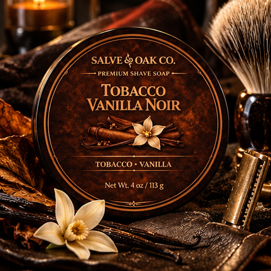 Tobacco Vanilla Noir premium shave soap surrounded by tobacco leaves, vanilla, dark wood, leather, and warm candlelit tones